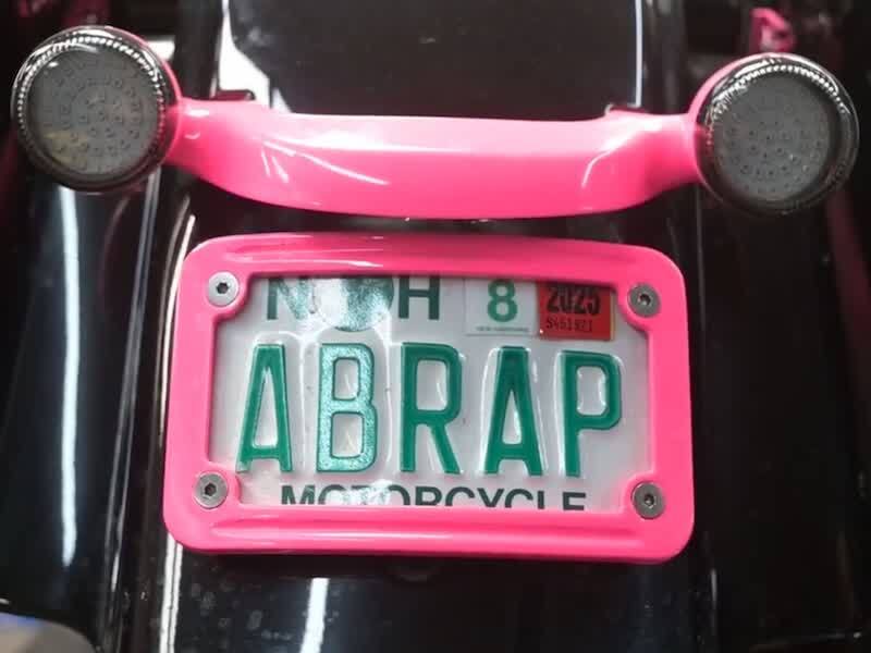 A side panel on Amy Brassard's motorcycle incorporates their dog’s ashes, keeping a beloved pet “riding along” with her.