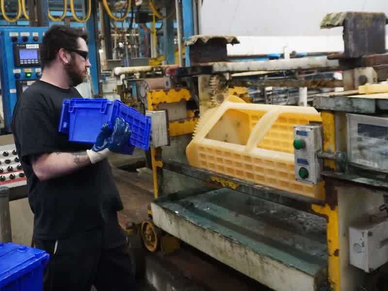 Garrett Nadicksbernd loads oparts into a barrel line at Varland Plating.