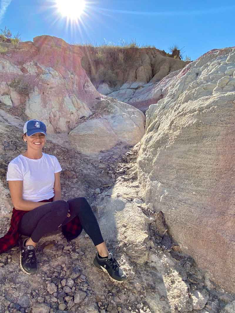 woman sitting among rocks