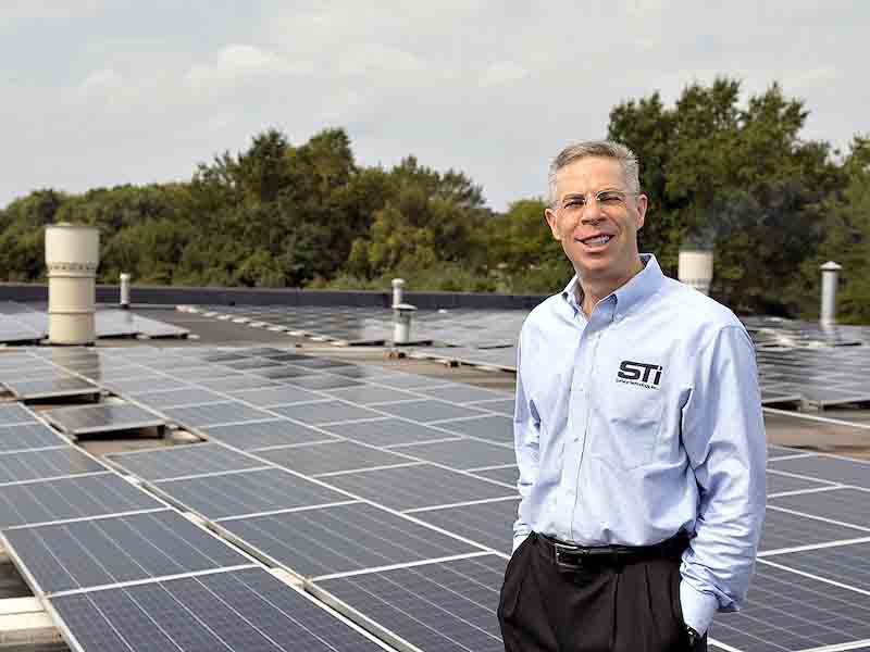 man standing on roof of building