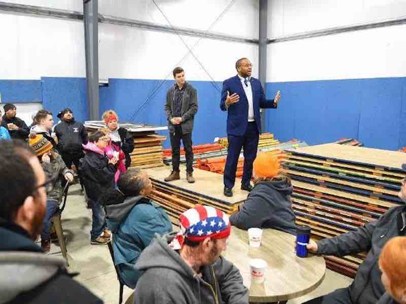 Ryan Kaplan, production manager at Multilink, and Elyria Mayor Frank Whitfield speak to those gathered.