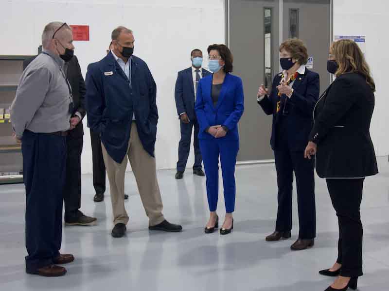 people standing on a shop floor