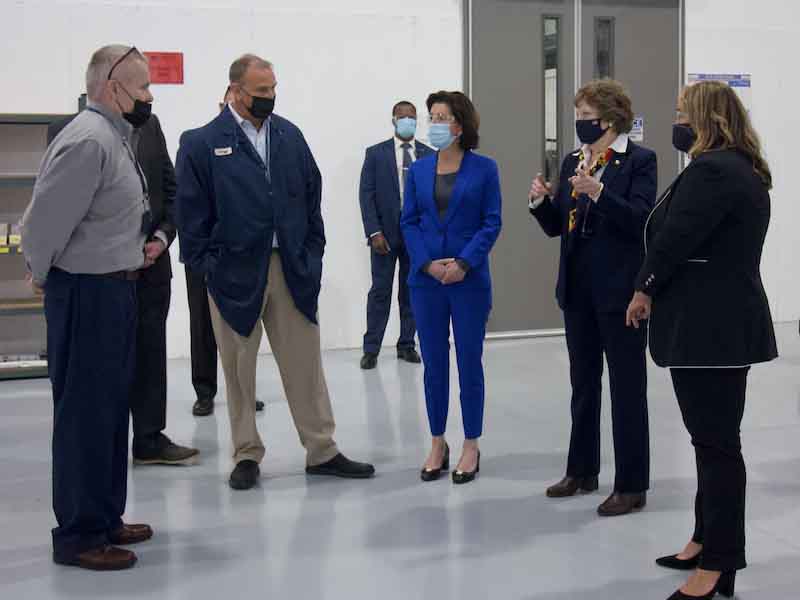 people standing on a shop floor