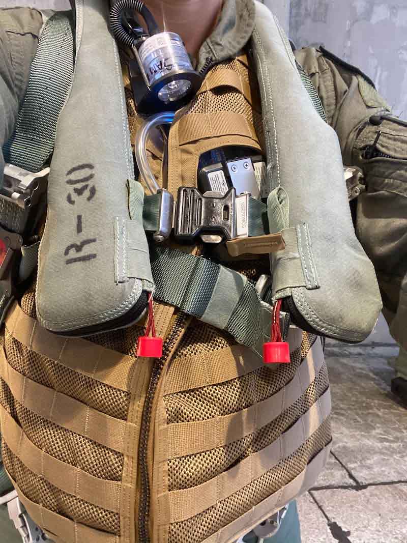 U.S. Air Force Capt. Christina Hall, a Human Performance Optimization Flight aerospace physiologist, displays her pre-flight gear at Kadena Air Base, Japan, Jan. 27, 2021. Hall volunteered to be the test subject in an investigation, looking into the potential exposure to carcinogens for personnel working with fighter jets. (Courtesy photo)