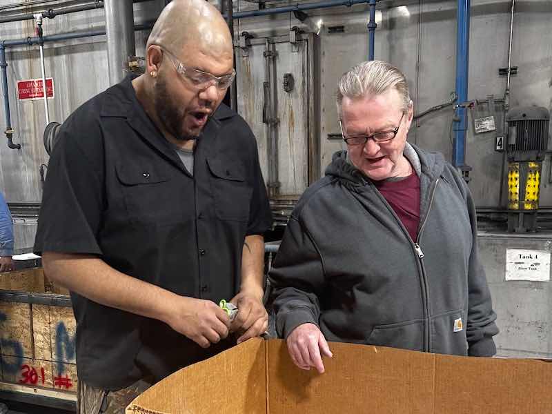 Frank Van Warmer, right, is now a second shift supervisor, and started working for the powder coating applicator before his release from the center.