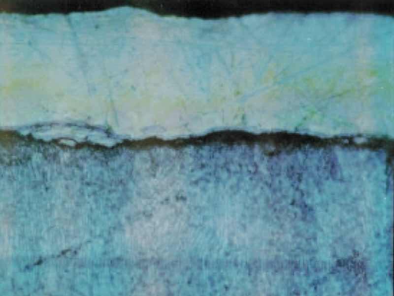 Microscopic cross section, 400X, blistered nickel-silver electroplate over zinc diecasting caused by inadequate copper strike
