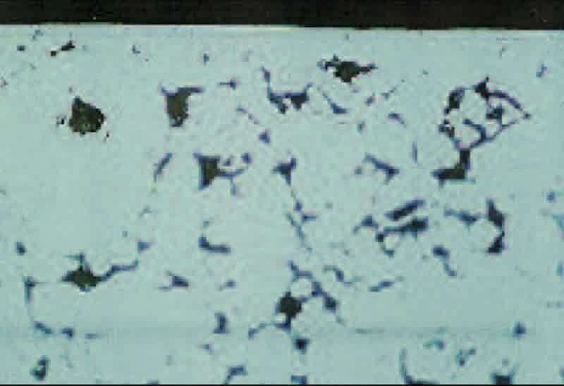 This is a cross-section (400X) of a notch in the area where staining was observed on the plated parts. Note the deep, large surface pores present, and the absence of any resin filling the pores, indicating poor impregnation of this area.