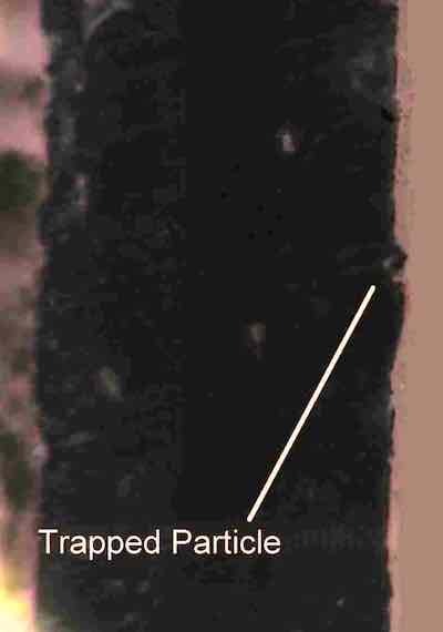 Photo 3—Cross-section showing trapped particle.