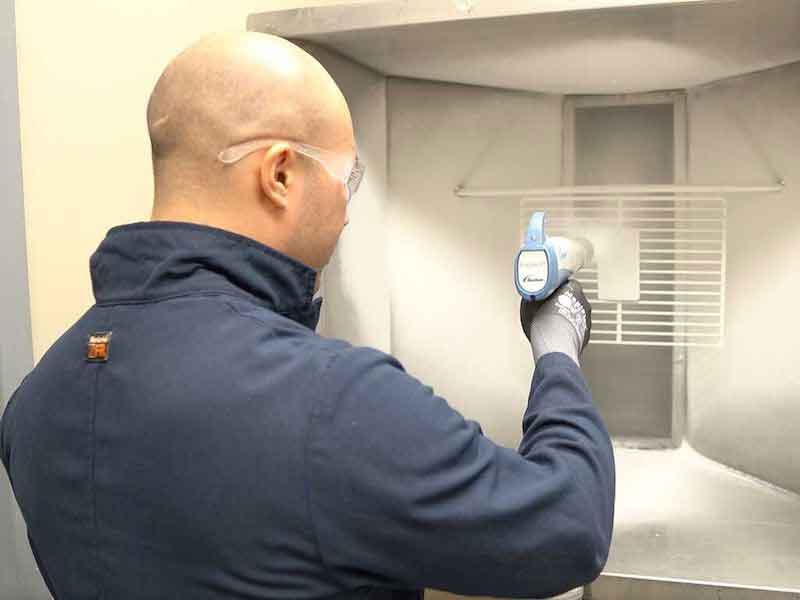 man spraying powder