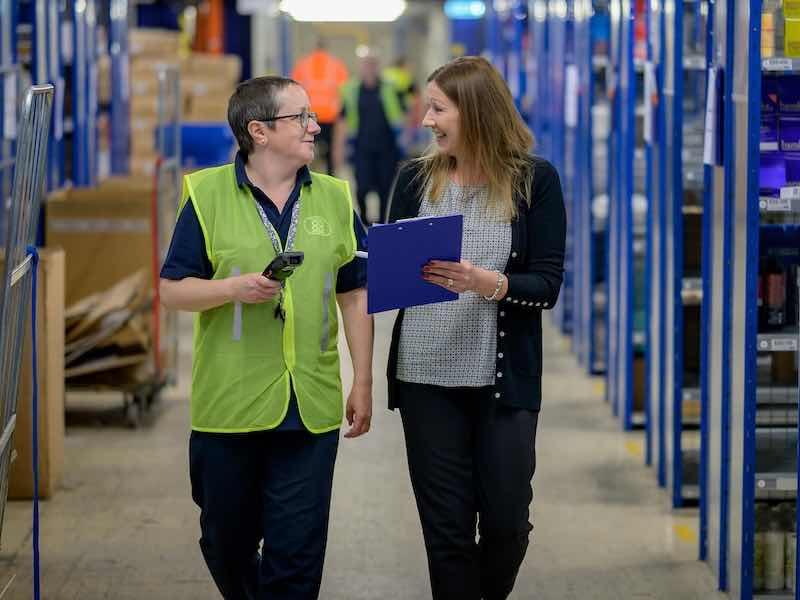 two employees walking and talking