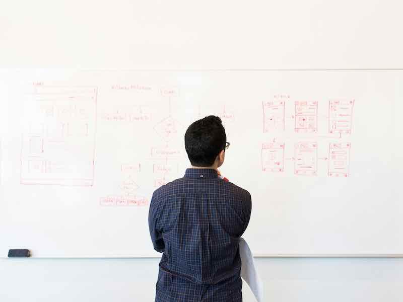 man standing before whiteboard