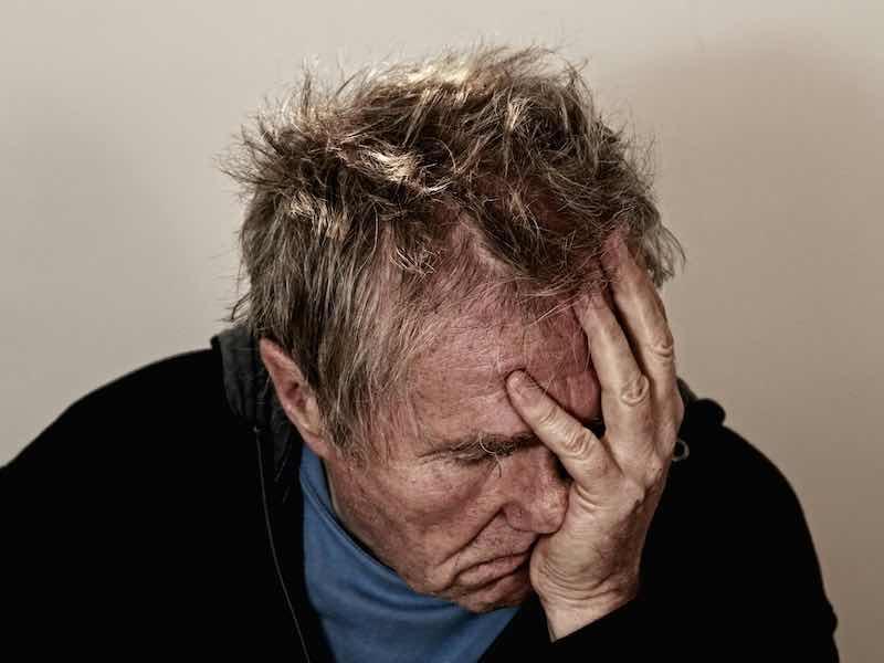man with head in hands