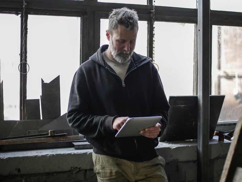 man looking at ipad