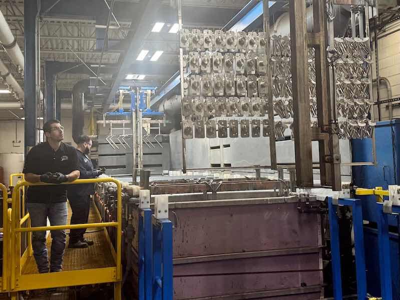 Ross Henry watches parts come out of the tank at ChromeTech.
