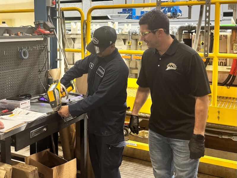 Ross checks on a project on the shop floor.