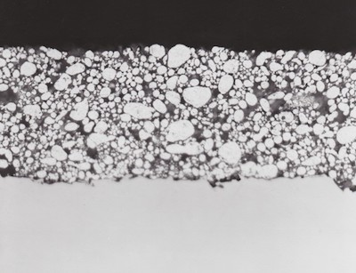 FIGURE 1: Aluminum powder particles cemented together by chromate/phosphate binder protects steels and other alloys from oxidation and corrosion up to 1000oF (538oC).