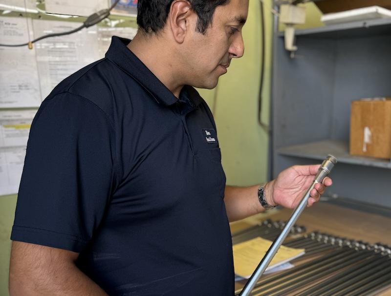 man looking at parts