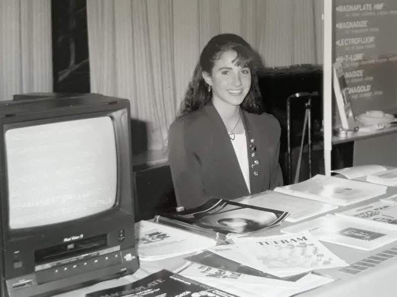 Ashley Russo works the General Magnaplate table in 1990 at a trade show.