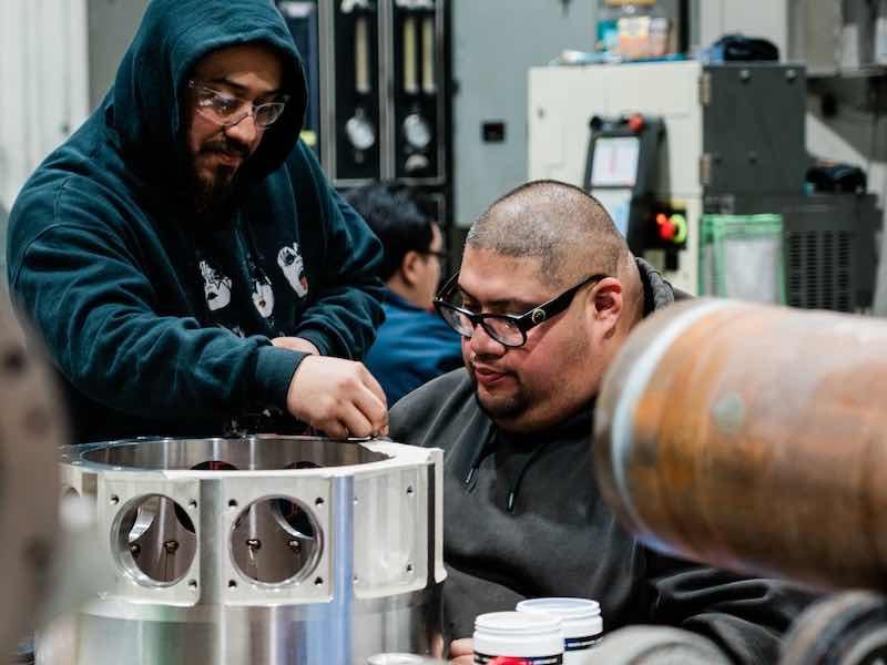 men working on parts