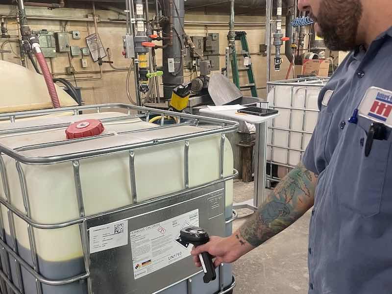 man scanning chemicals