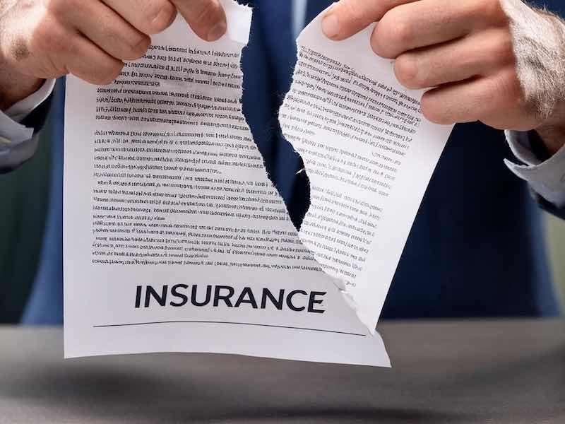 insurance policy being ripped in two
