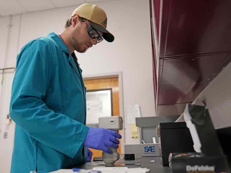 Chandler Watson, 802nd Maintenance Support Squadron Chemical Analysis Laboratory chemist, calibrates a paint quality spectrophotometer at Robins Air Force Base, Georgia, July 30, 2025. The calibrated spectrophotometer ensured paint was the correct color and density to be applied to aircraft during the overhaul and repair process. (U.S. Air Force photo by Joseph Mather)