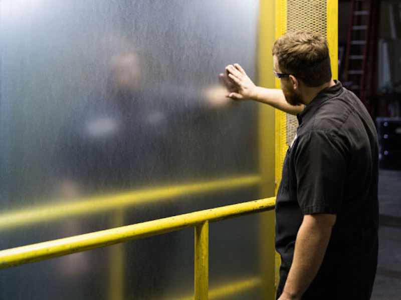 man touching a steel surface