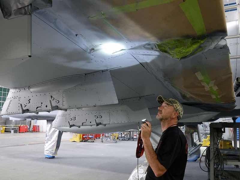 576th Aircraft Maintenance Squadron corrosion control painter Dale Benoit inspects newly applied paint on the underside of the new wing of an A-10 Thunderbolt II, tail no. 80-0252, at Hill Air Force Base, Utah, July 3, 2019. The aircraft was the last of 173 A-10s to receive new wings under the Enhanced Wing Assembly program to extend the flying service life of the fleet.  (U.S. Air Force photo by Alex R. Lloyd)