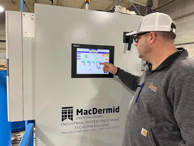 Plant Manager Joe Tekuelve checks on the new system's operation.