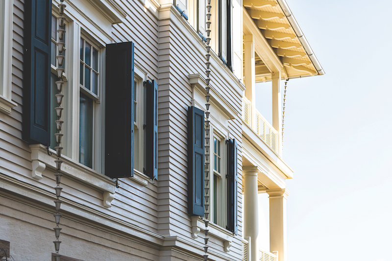 Pastel pink yellow colorful shutter windows architecture exterior of house in Florida beach home apartment building closeup