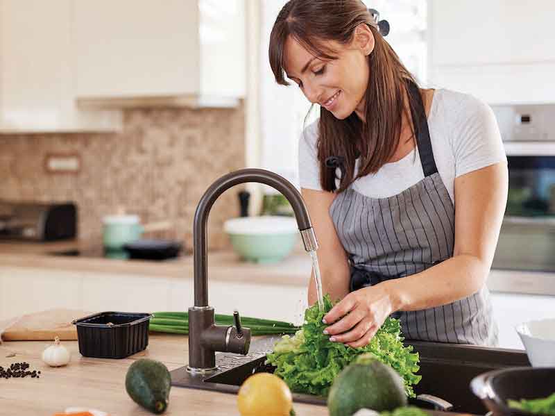 woman running water at a sink