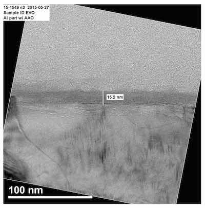 Figure 4: Transmission Electron Microscope(ic) (TEM) image of a vinyl phosphonic acid conversion- coated aluminum alloy enhanced with a polymer modifier (acrylic acid). The initial thickness of the conversion coating, without the modifier, was reported to be the same thickness as the passive layer on the aluminum (maximum 10 nanometers). By adding acrylic acid as a long-chain modifier to the conversion coating formulation, additional thickness was obtained. The final layer measured 15 nanometers thick.