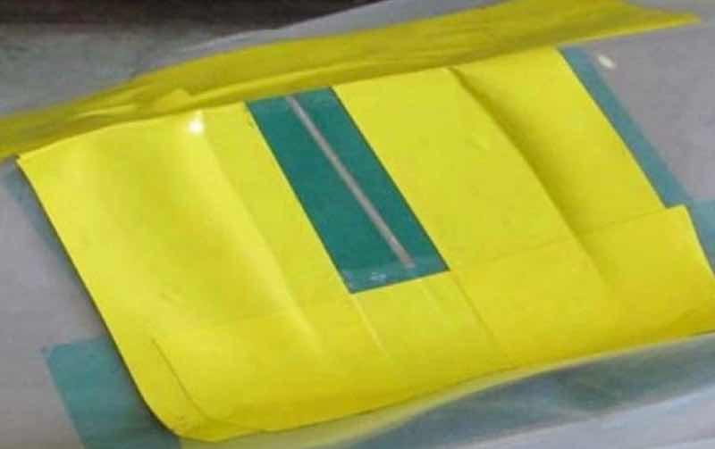 Figure 12- Repair of a severe scratch in a chromic acid anodized coating, showing the finish to be completely blended-in.