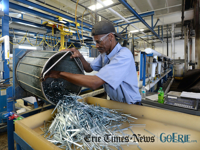 Willie Dixon, sorts rods that have just been zinc plated at Great Lakes Metal Finishing Inc. in Erie. [JACK HANRAHAN/ERIE TIMES-NEWS]