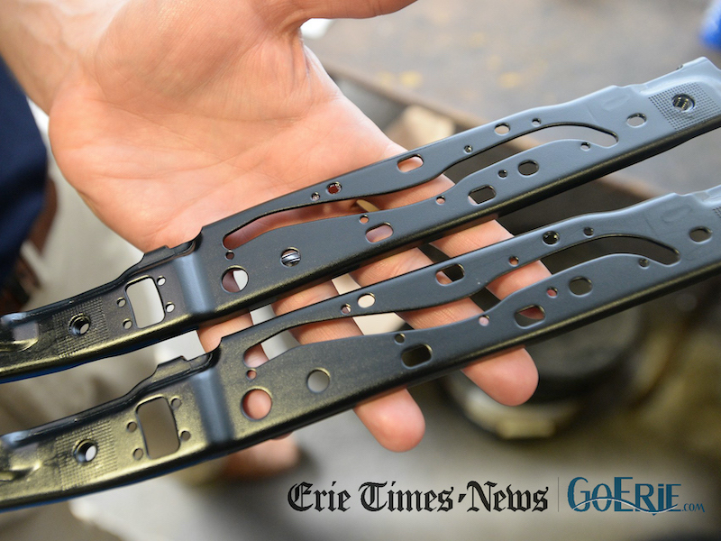 These brackets will be used by automaker Honda for a sunroof assembly. [JACK HANRAHAN/ERIE TIMES-NEWS]