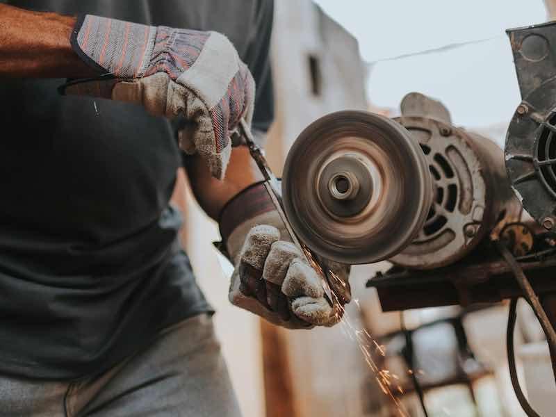 person grinding parts