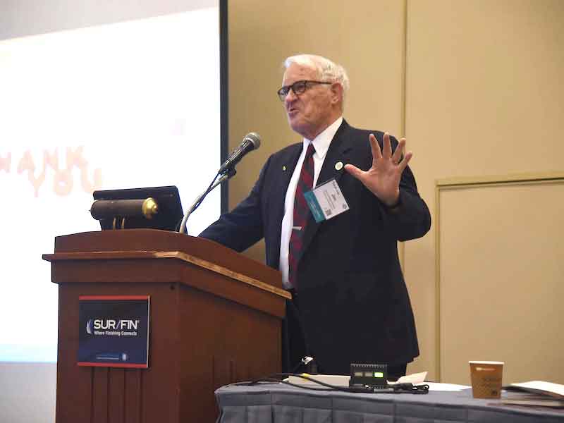 man speaking at a lecturn
