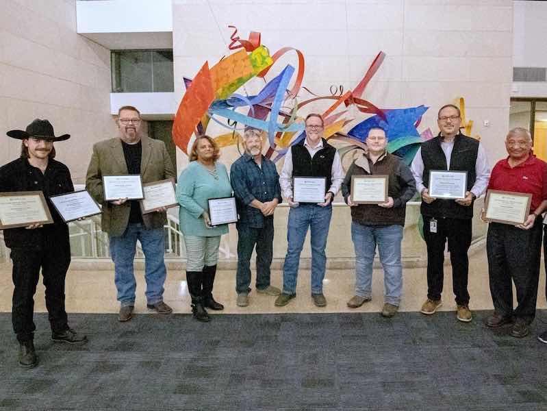 winners holding certificates