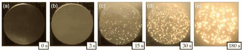 Figure 2. Evolution of PEO discharge stages: (a) at coating start before power is applied; (b) when power is applied, surface oxidation begins. (c) Dielectric breakdown is reached, and small discharges are visible; (d) soft arcing starts and plasma discharges are visible; (e) strong arcing, and large discharges are visible and less frequent. Reproduced from [2], Coatings MDPI, 2020.
